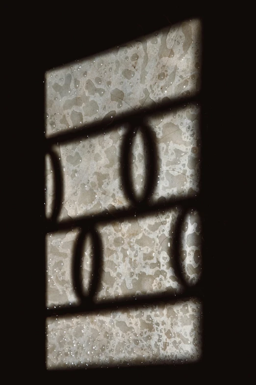 a close up of a window with a pattern on it, inspired by Raoul Ubac, moon backlight, textured in substance, 2010s, drop shadow