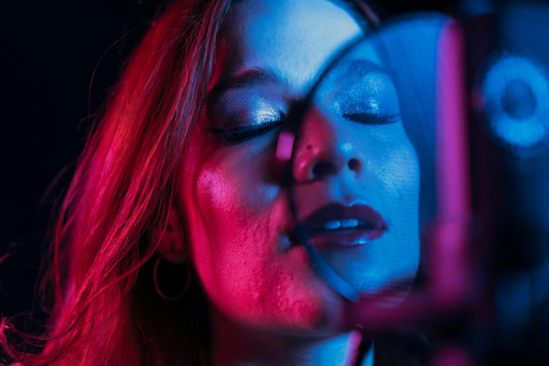 a woman looking at her reflection in a mirror, an album cover, inspired by Nan Goldin, pexels contest winner, red and blue neon, miranda otto, glowing mouth, nightlife