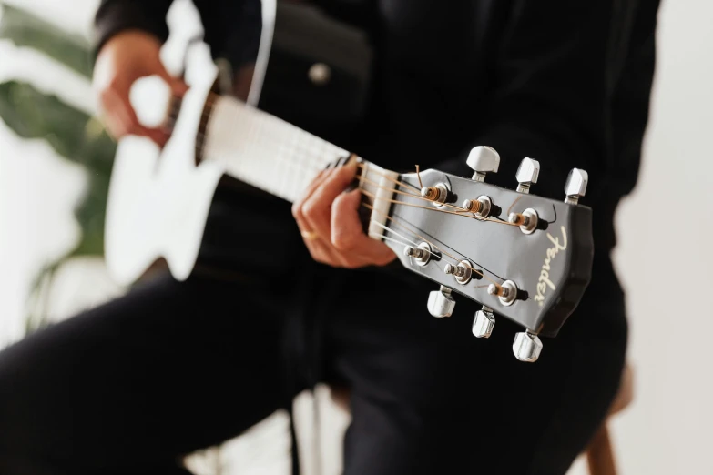 a close up of a person playing a guitar, profile image