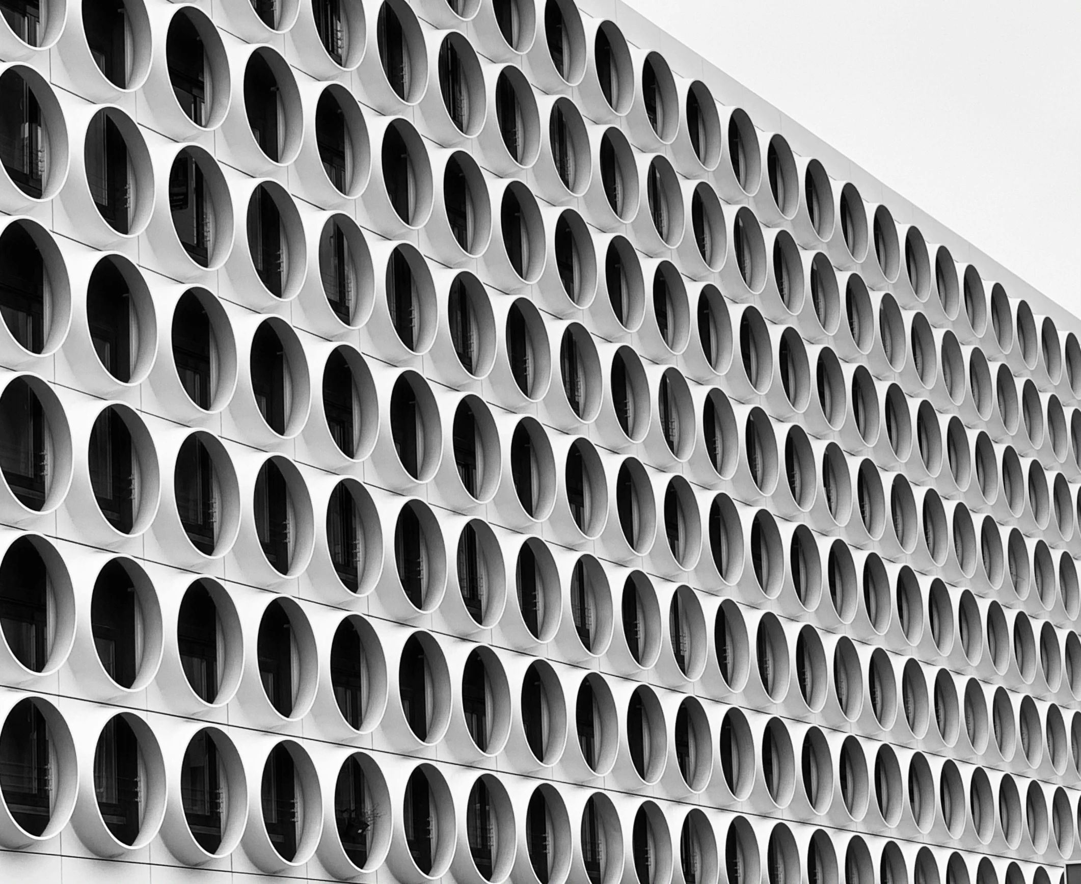 a black and white photo of a building, by Sven Erixson, pexels contest winner, brutalism, brown holes, porcelain, munich, circles