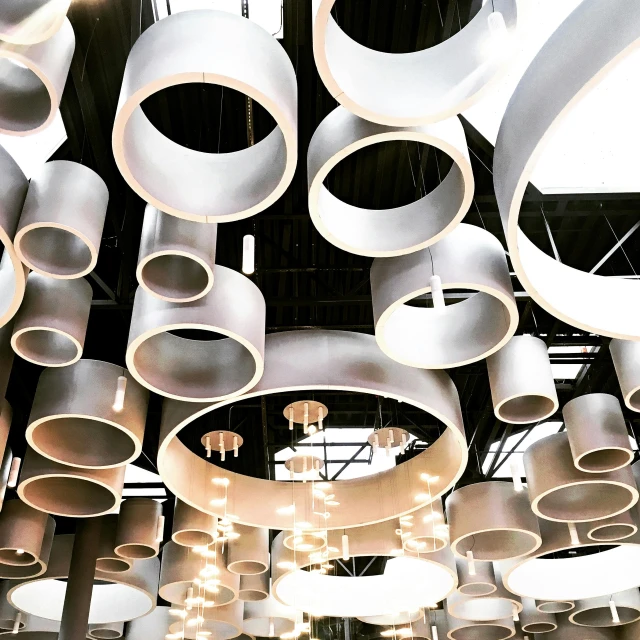 a bunch of lights that are hanging from the ceiling, unsplash, kinetic art, large pipes, eero aarnio, circular, jc park