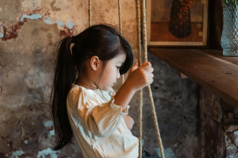 a little girl that is sitting on a swing, pexels contest winner, looking her shoulder, wabi sabi, diy, young asian girl