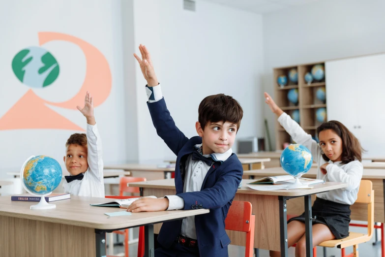 a group of children sitting at desks in a classroom, pexels contest winner, danube school, his arms spread. ready to fly, avatar image