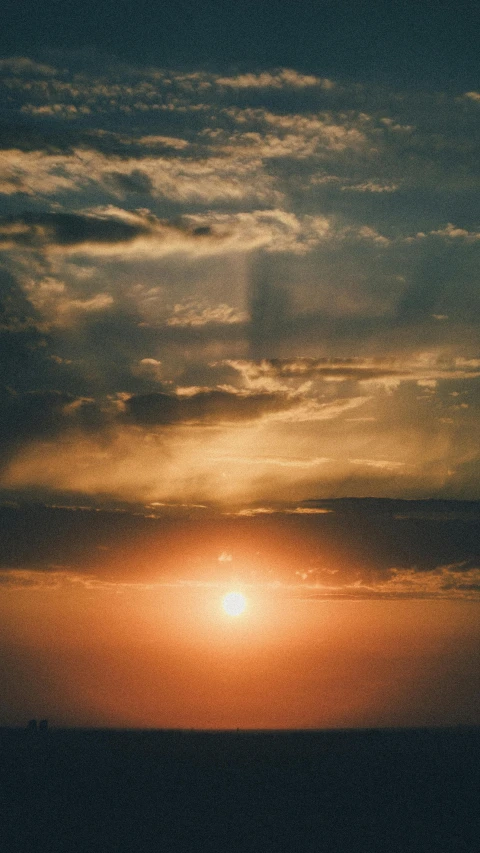 the sun is setting behind the clouds in the sky, pexels, instagram post, high quality photo, golden light film grain, uploaded
