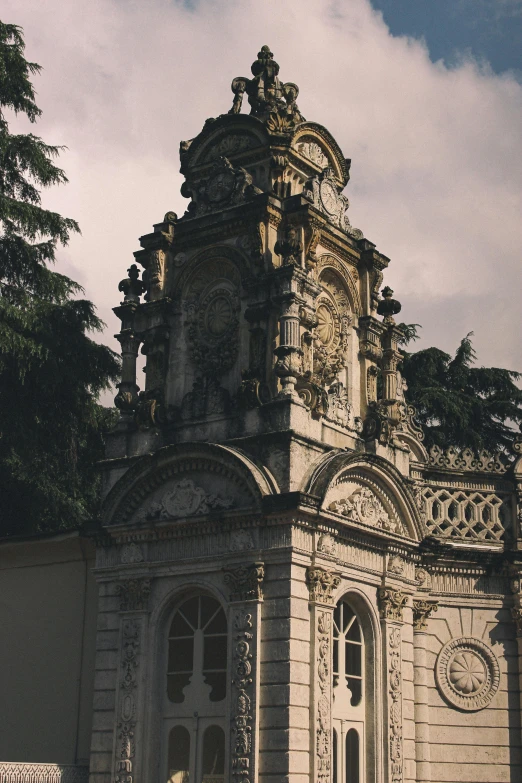 a tall building with a clock on top of it, inspired by Jacopo Amigoni, baroque, mausoleum ruins, moody details, botanical garden, trending photo