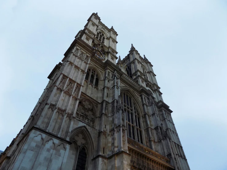 a very tall building with a clock on it's side, an album cover, unsplash, baroque, alabaster gothic cathedral, underwater westminster, thumbnail, exterior photo