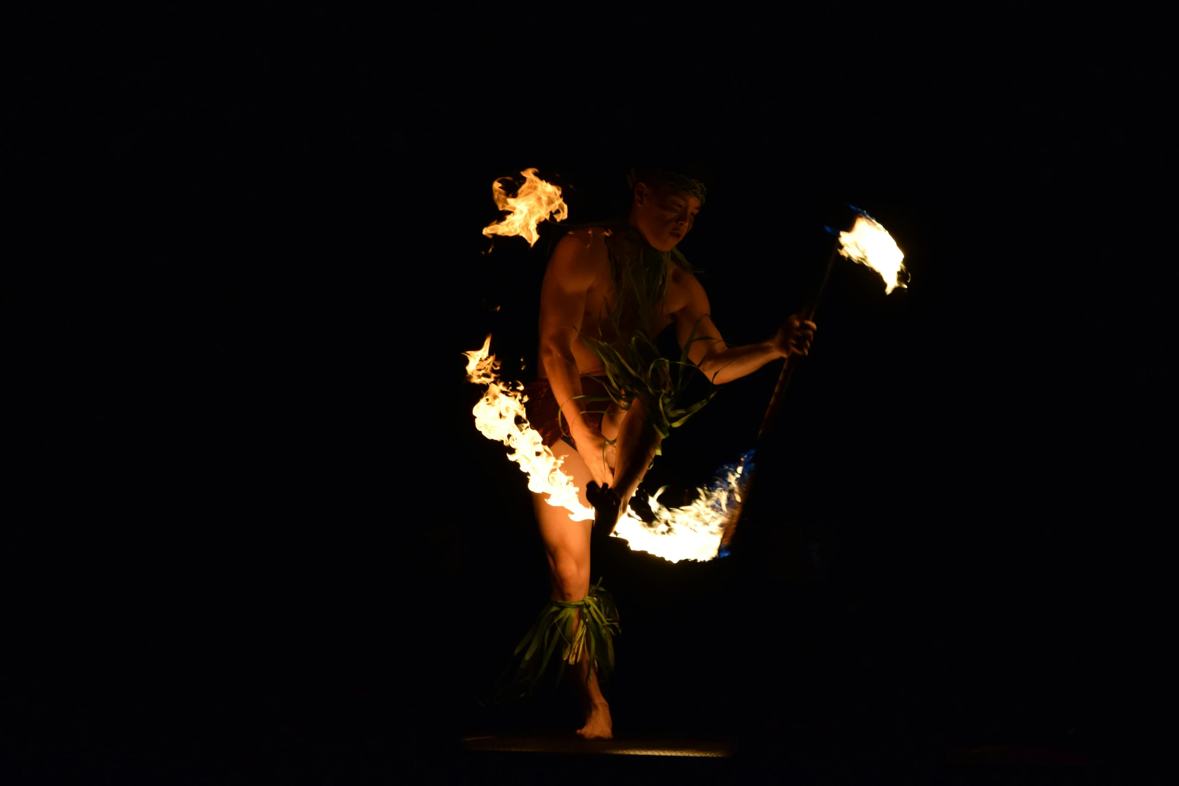 a man that is standing in the dark with fire, polynesian style, photograph taken in 2 0 2 0, square, stage photography
