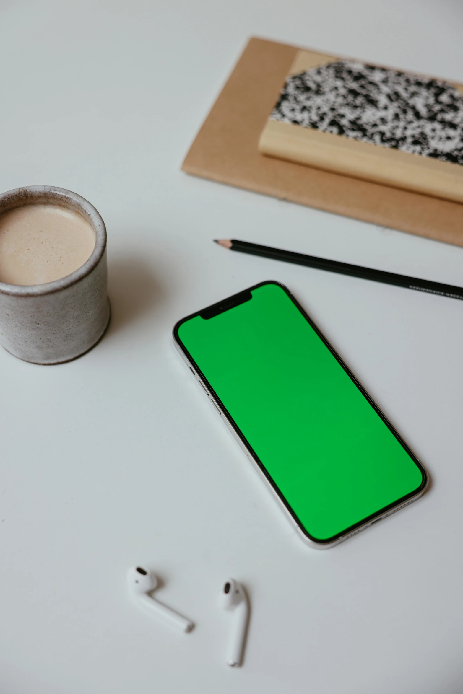 a cell phone sitting on top of a table next to a cup of coffee, trending on pexels, computer art, green screen, square, no - text no - logo, bold black lines