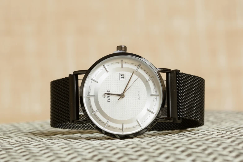 a close up of a watch on a table, a stipple, inspired by Ernst, reddit, bauhaus, glossy white metal, thumbnail, grid, looking regal and classic