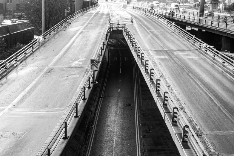 a black and white photo of a highway, a black and white photo, unsplash, the tunnel into winter, bridges and railings, in the middle of the city, 2 0 0 0's photo