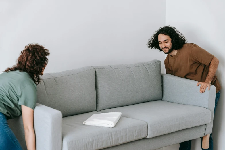 a man and a woman moving a couch, pexels contest winner, minimalism, asmongold, background image, conversation pit, 2 people