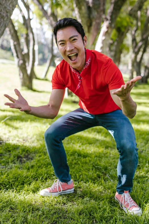 a man that is standing in the grass with a frisbee, shutterstock contest winner, happening, kawaii playful pose of a dancer, red shirt brown pants, ernie chan, manically laughing