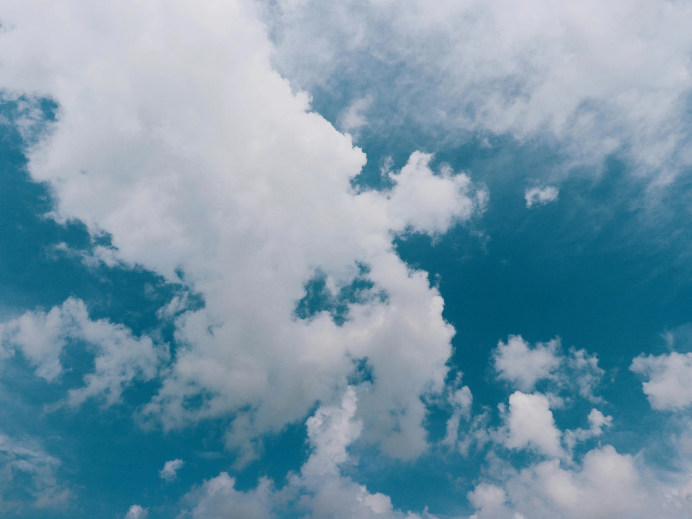 a person is flying a kite in the sky, pexels contest winner, minimalism, cumulus clouds, looking up onto the sky, today\'s featured photograph 4k, sky blue