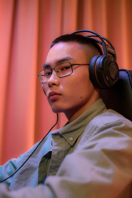 a man sitting in a chair with headphones on, inspired by Li Tiefu, reddit, halfbody headshot, esports, profile image, large)}]