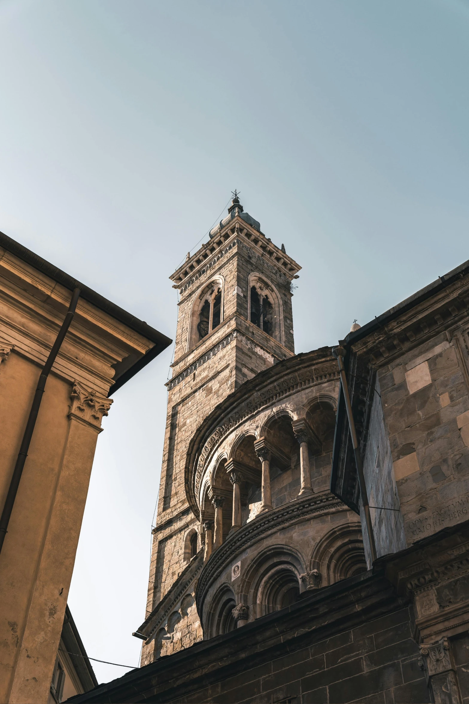 a tall tower with a clock on top of it, inspired by Taddeo Gaddi, pexels contest winner, romanesque, domes, high light on the left, high view, nepali architecture buildings