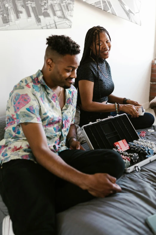 a couple of people sitting on top of a bed, an album cover, trending on unsplash, black arts movement, holding a briefcase, playing games, lgbtq, high quality photo