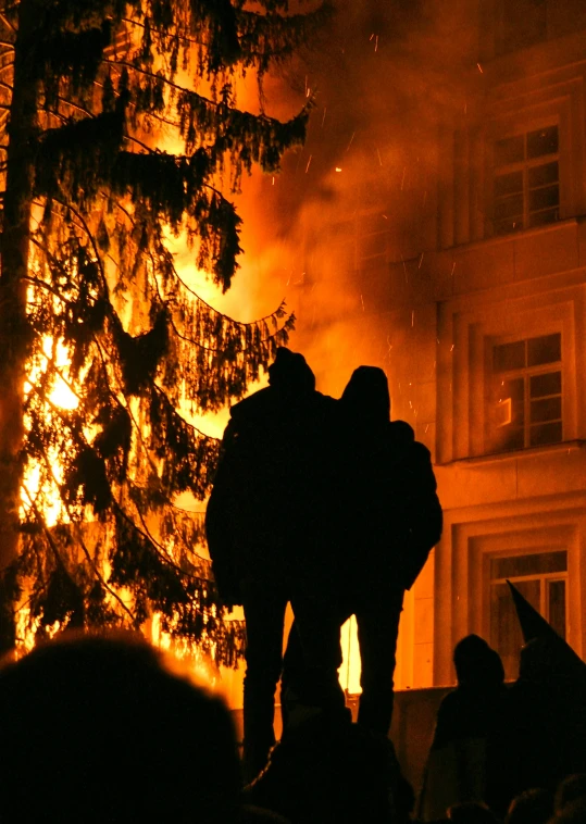 a group of people standing in front of a fire, lviv, profile image, burning trees, 2 0 0 4 photograph