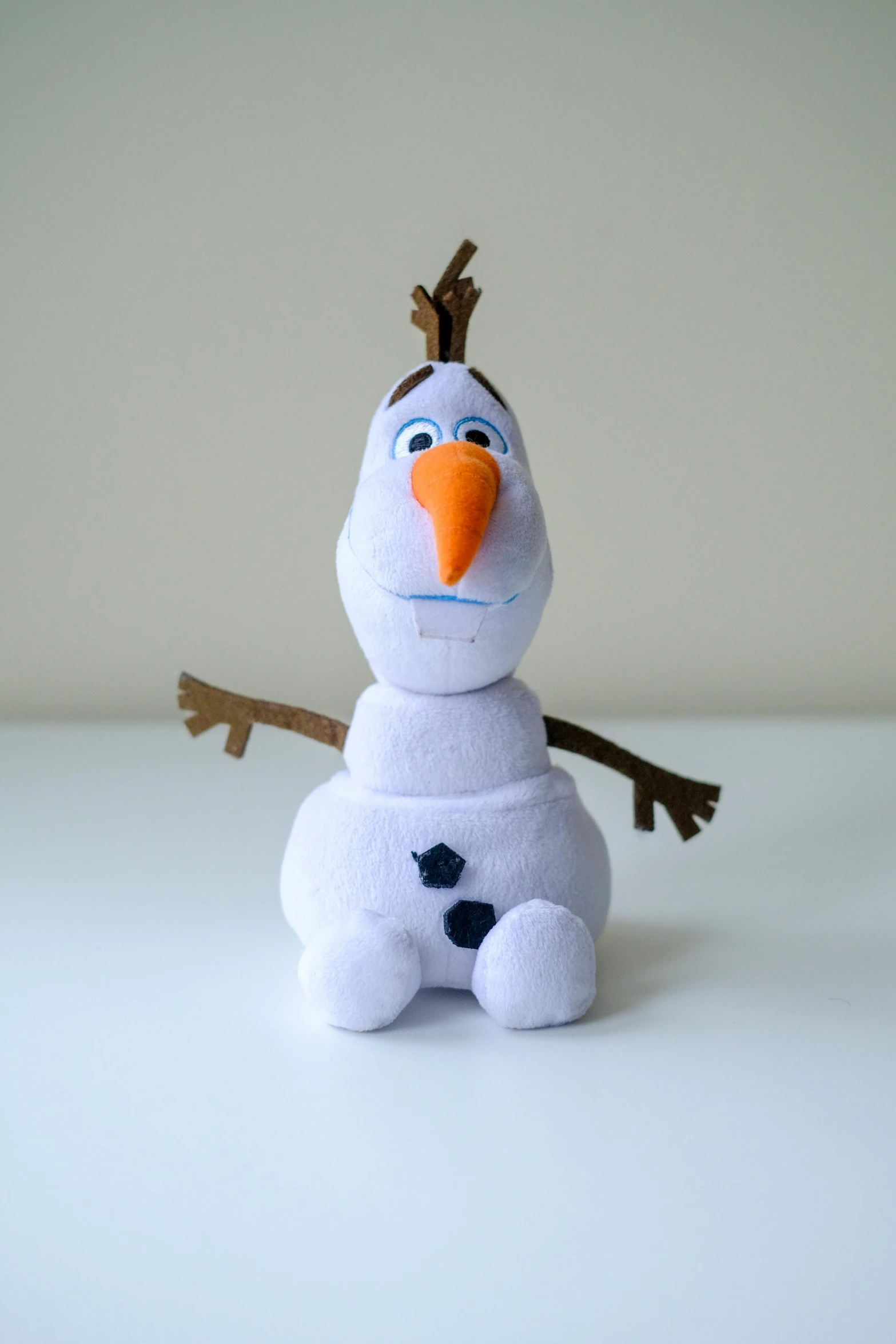 a close up of a stuffed snowman on a table, a cartoon, inspired by Olaf Rude, happening, 3/4 front view, transforming, simba, product shot