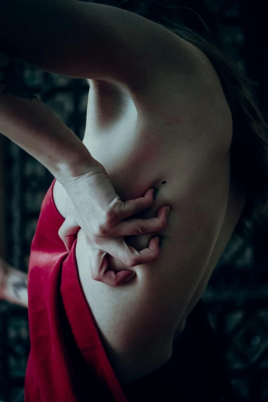a woman in a red dress holding her stomach, a tattoo, inspired by Elsa Bleda, unsplash contest winner, intimate dark moody, battle scars across body, gif, bulging veins