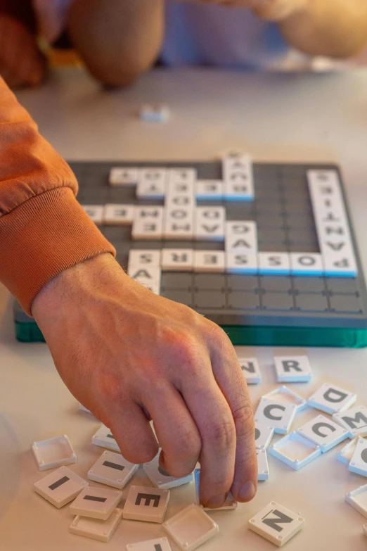 a close up of a person playing a game of scrabble, a jigsaw puzzle, slide show, sculpting, words