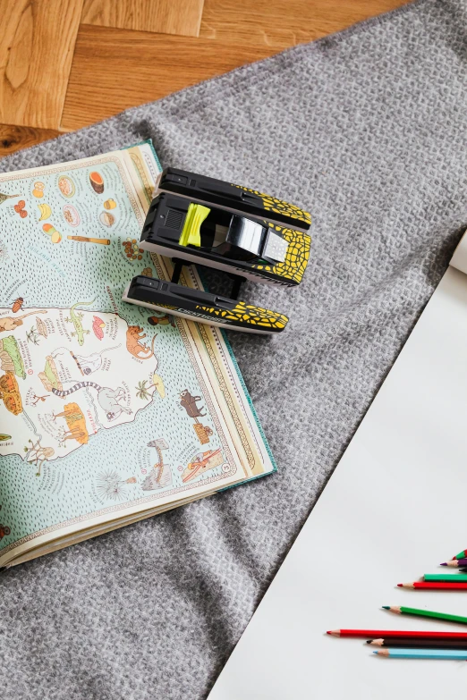 an open book sitting on top of a table next to a cup of coffee, a child's drawing, inspired by Randolph Caldecott, trending on pexels, graffiti, miniature of a sports car, floating cars, with fluo colored details, childs bedroom