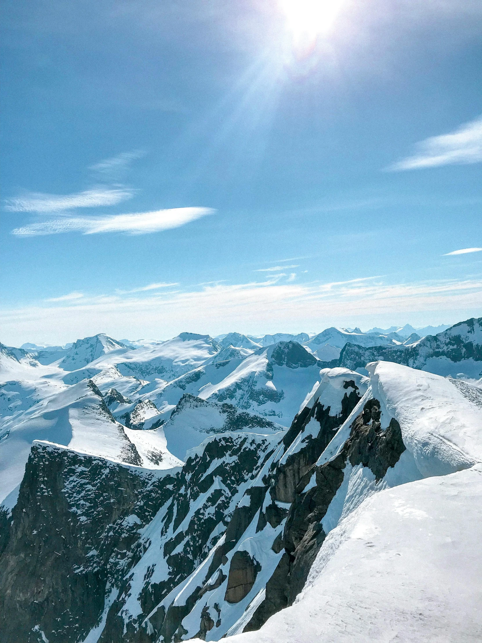 a man standing on top of a snow covered mountain, banff national park, profile image