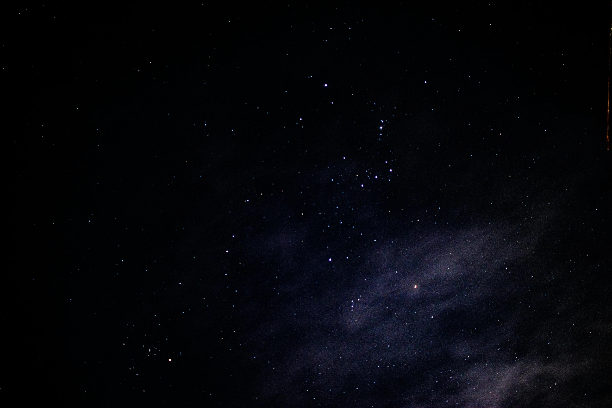 a man riding a snowboard on top of a snow covered slope, an album cover, pexels, light and space, black sky full of stars, purple nebula, close - up photograph, star(sky) starry_sky