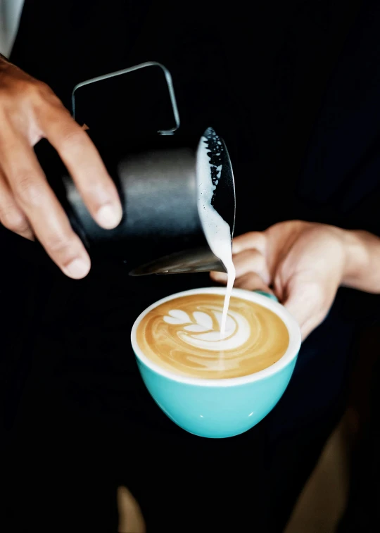 a person pouring milk into a cup of coffee, by Jessie Algie, instagram photo, award-winning crisp details”, 9 9 designs, vivid)