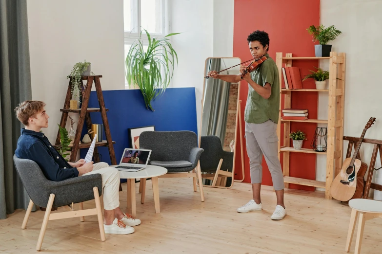 a man playing a violin in a living room, by Julia Pishtar, interactive art, office furniture, calmly conversing 8k, teenager hangout spot, ikea catalogue photo