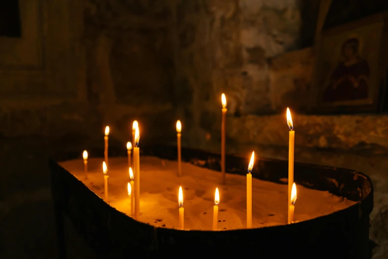 a group of lit candles sitting on top of a wooden table, pexels, baroque, rising from a crypt, jerusalem, st cirq lapopie, day light