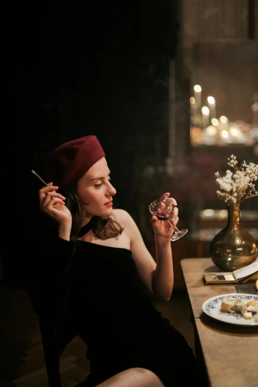 a woman sitting at a table with a plate of food, a portrait, trending on pexels, renaissance, long night cap, smoking, velvet, instagram picture