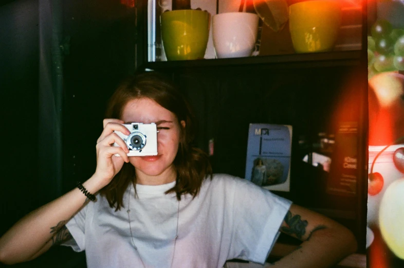 a woman taking a picture of herself with a camera, a polaroid photo, inspired by Elsa Bleda, unsplash contest winner, private press, sadie sink, low colour, photocopied, cute photo