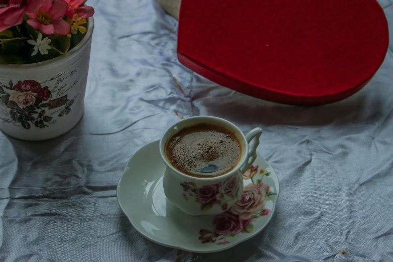 a cup of coffee sitting on top of a saucer, turkey, flowers around, promo image, fan favorite