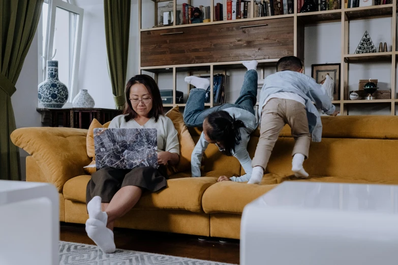 a couple of people that are sitting on a couch, pexels contest winner, families playing, an asian woman, maintenance photo, - 9