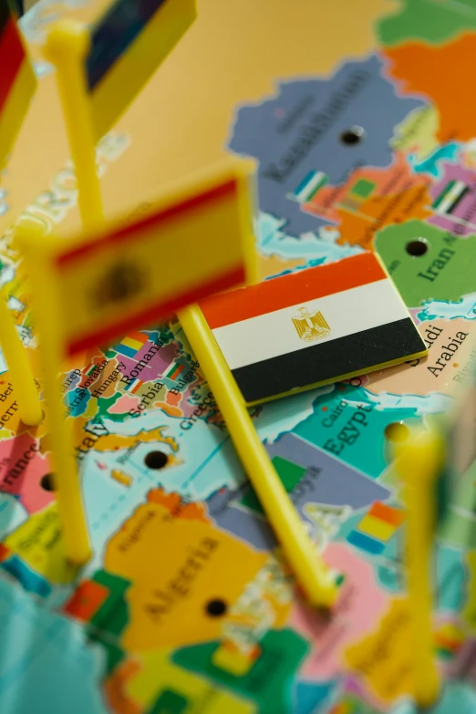 a bunch of pins sitting on top of a map, by Julia Pishtar, shutterstock, happening, egyptian, flags, yellow, instagram post