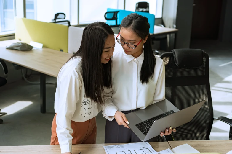 two women looking at a laptop in an office, pexels contest winner, asian descend, avatar image, background image, holding each other