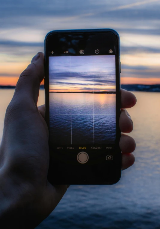 a person taking a picture with their cell phone, a picture, by Jesper Knudsen, pexels contest winner, on a lake, panels, ilustration, iphone video