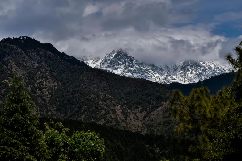 a mountain range with snow capped mountains in the distance, pexels contest winner, hurufiyya, indian forest, thumbnail, uttarakhand, multiple stories