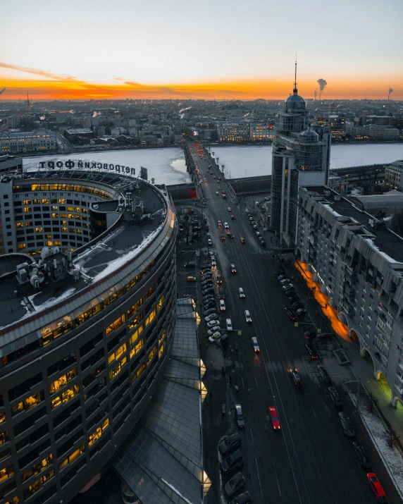 an aerial view of a city at sunset, pexels contest winner, socialist realism, russian architecture, intersection, brutalist style, helipad