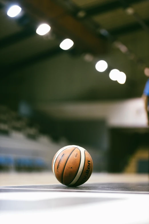 a basketball ball sitting on top of a court, looking off to the side, sports illustrated, gettyimages, center spotlight