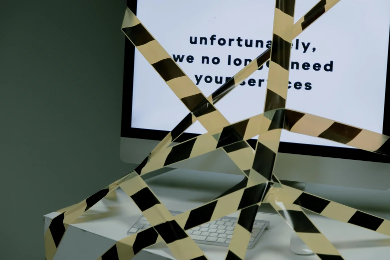 a computer monitor sitting on top of a desk, by Matija Jama, computer art, police tape, broken signs, words, 'untitled 9 '