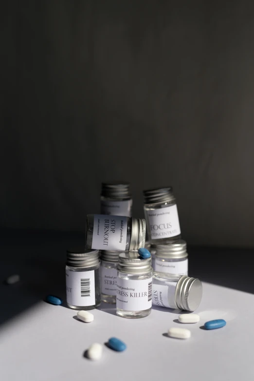 a pile of pills sitting on top of a table, inspired by Cerith Wyn Evans, unsplash, hyperrealism, labels, grey, vials, ilustration