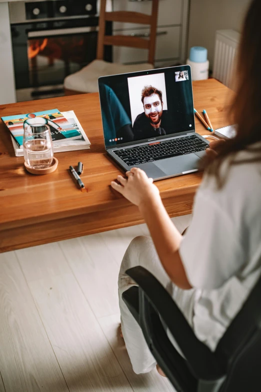 a woman sitting in a chair in front of a laptop computer, trending on pexels, video art, in meeting together, romantic lead, face showing, instagram picture