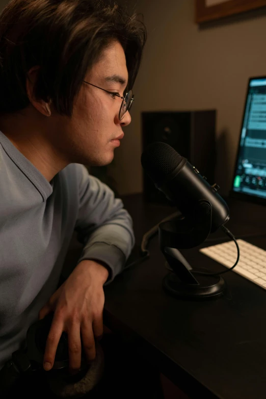 a man sitting at a desk in front of a computer, inspired by Zhu Da, sitting in front of a microphone, taken with sony alpha 9, programming, ultra - detailed