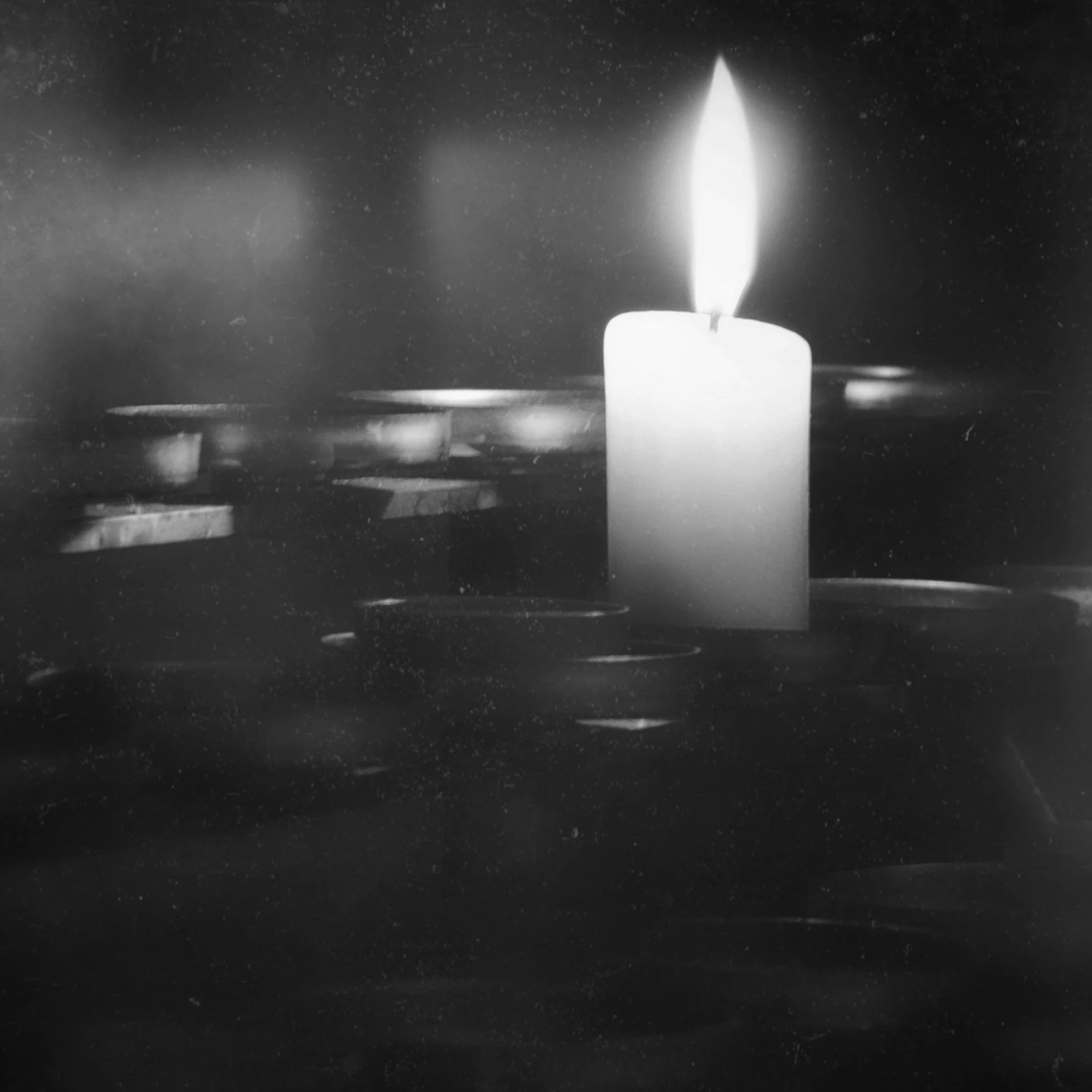 a lit candle sitting on top of a table, inspired by Roy DeCarava, flickr, shot on expired kodak film, 1 9 7 5 photo