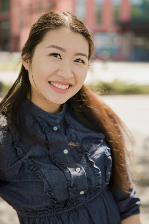 a woman in a blue shirt posing for a picture, inspired by Feng Zhu, square, 8k 50mm iso 10, smiling sweetly, large)}]