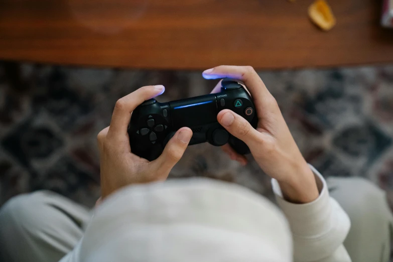 a woman sitting on the floor playing with her nintendo wii