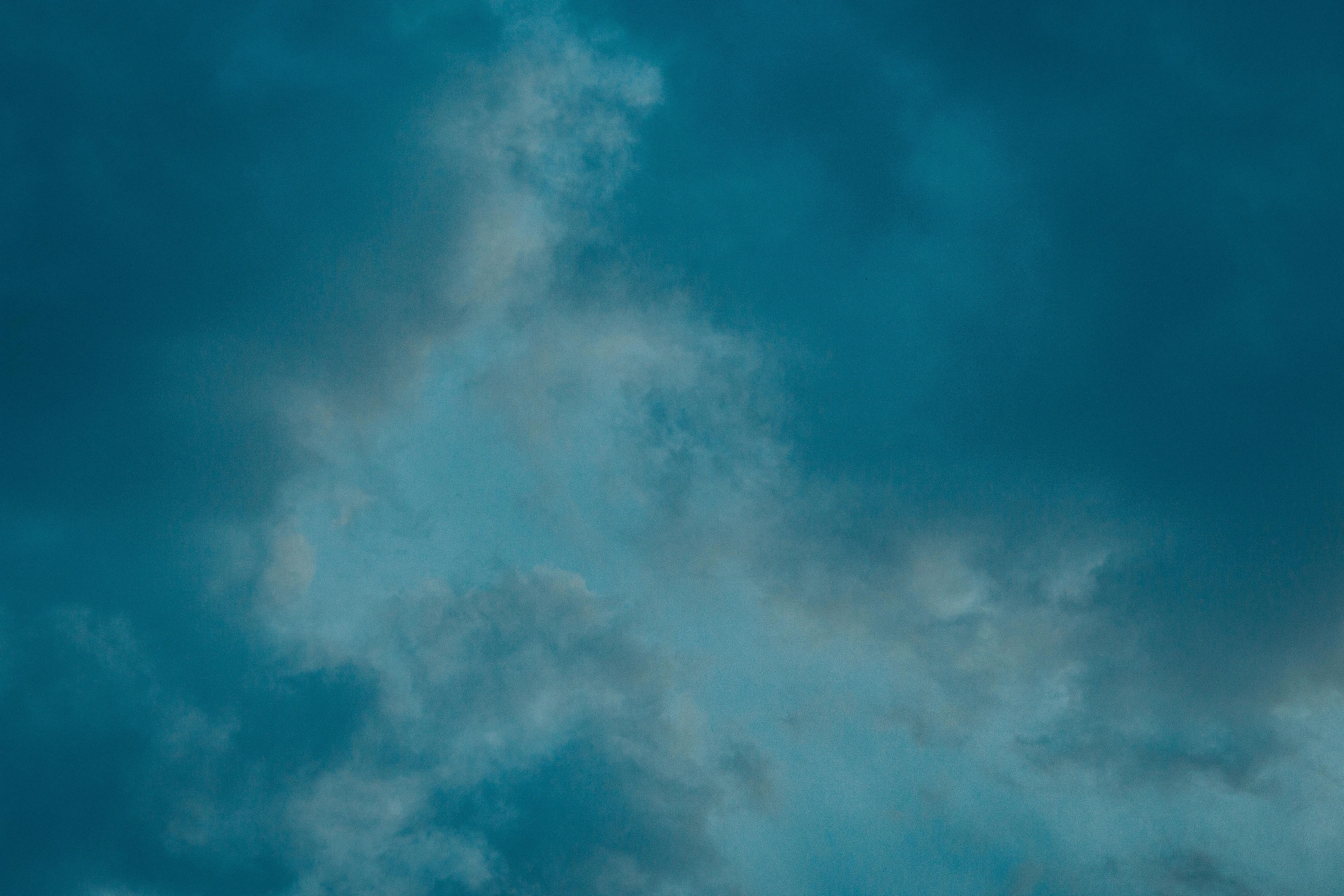 a plane flying through a cloudy blue sky, an album cover, inspired by Elsa Bleda, pexels contest winner, baroque, soft blue texture, (night), overcast, cyan