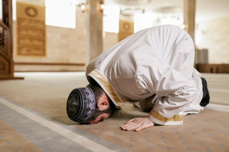 a man that is kneeling down on the ground, a picture, by Meredith Dillman, shutterstock, hurufiyya, cybermosque interior, hat covering eyes, instagram post, bending over