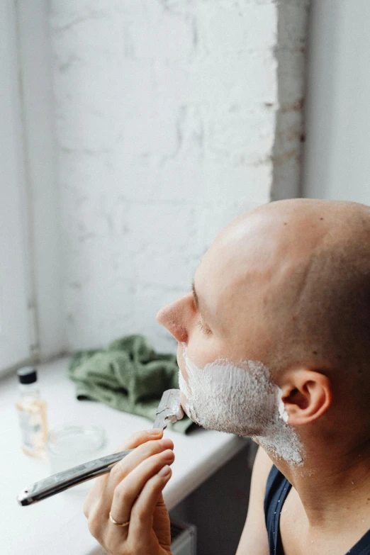 a bald man shaving his face with a razor, pexels contest winner, renaissance, gushy gills and blush, profile image, square facial structure, pale grey skin